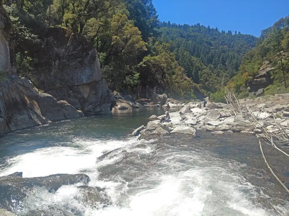 Whitewater rapids on the South Fork of the American River below steep forested canyon slopes